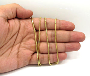 gold figaro chain on hand